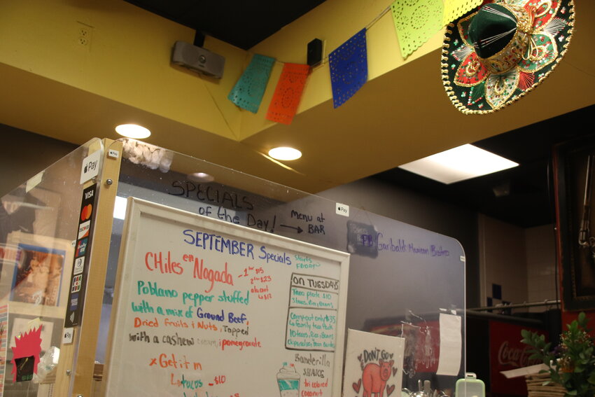 Decorations hang near the counter at Garibaldi Mexican Bistro Sept. 6 in Englewood. A white board lists specials.